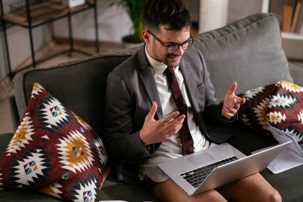istock Young man using the laptop having video call. 1287108003