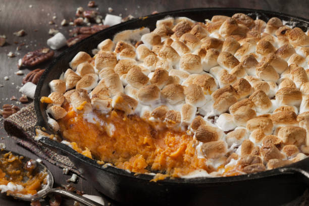 Sweet Potato Casserole with Pecans and Marshmallows Sweet Potato Casserole with Pecans and Marshmallows sweet potato photos stock pictures, royalty-free photos & images