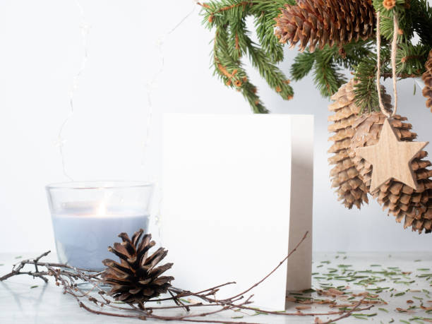 istock White empty paper near christmas decorations on white 1287109223
