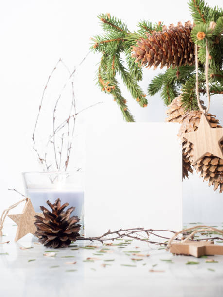 istock White empty paper near christmas decorations on white 1287109270