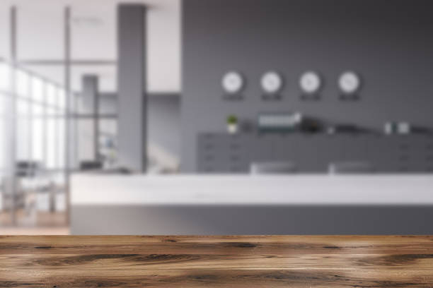 istock Table in gray office with reception and clocks 1287109291
