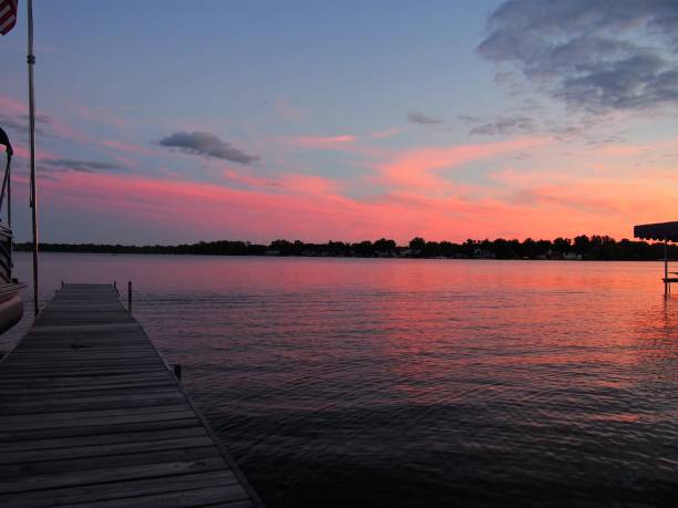 istock Old Wooden Dock on a Sunlit Lake 1287110027