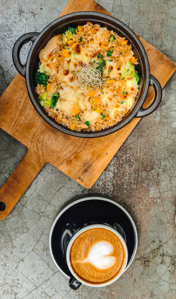 istock Vegetarian rice on a hot plate with a cup of coffee 1287110112