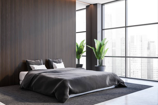 istock Stylish gray and dark wooden master bedroom corner 1287110131