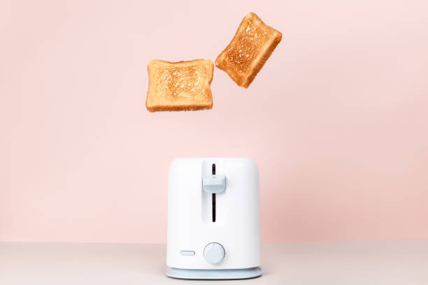 istock Toasts jumping out of white toaster. 1287111006