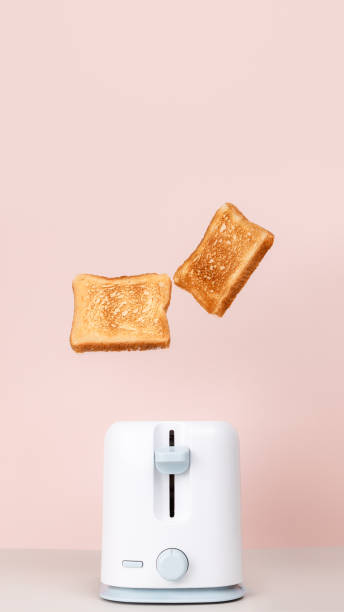 istock Toasts jumping out of white toaster. 1287111054
