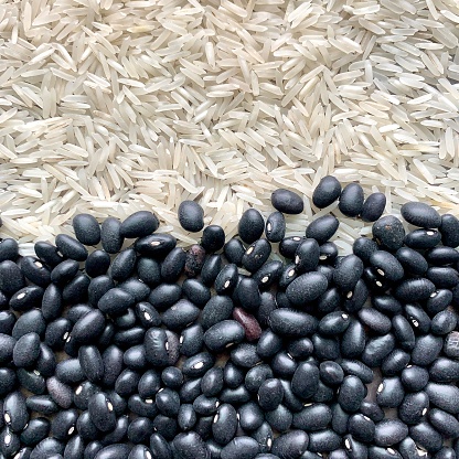 Uncooked rice and black beans background