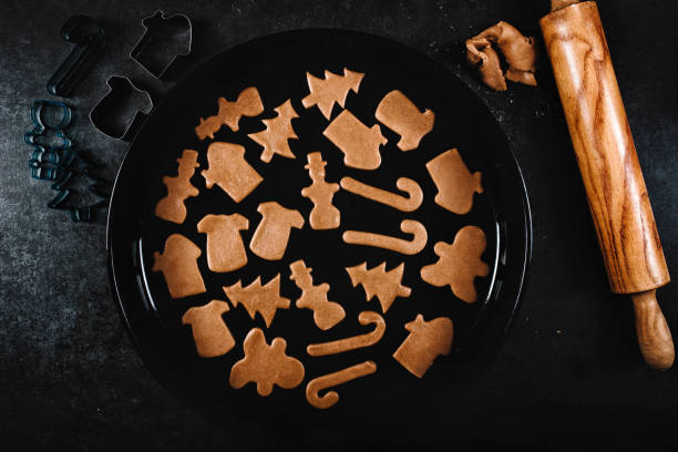 Shot of  black christmas baking background for making cake, biscuit or decorated homemade christmas gingerbread cookies. Top view with black slate, stone or concrete table. Shot with DSLR Canon 5DSR and Sigma 35mm ART series