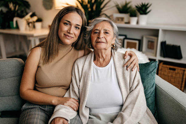 I love my grandma Senior women and her granddaughter talking in living room elderly parents stock pictures, royalty-free photos & images
