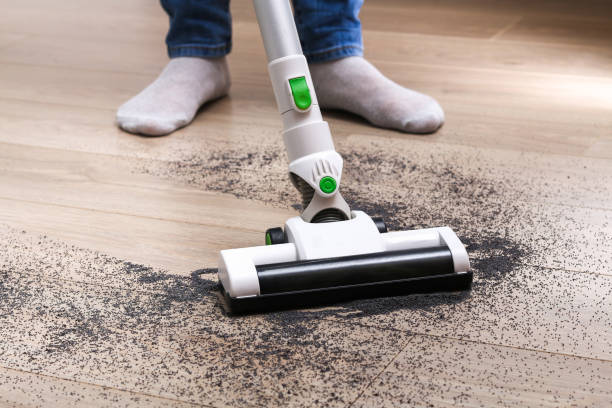 istock A man uses a bagless vertical cordless vacuum cleaner to clean floor. 1287113184