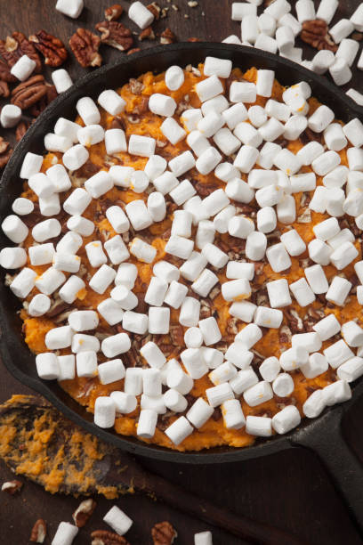 istock Preparing Sweet Potato Casserole with Pecans and Marshmallows 1287113219