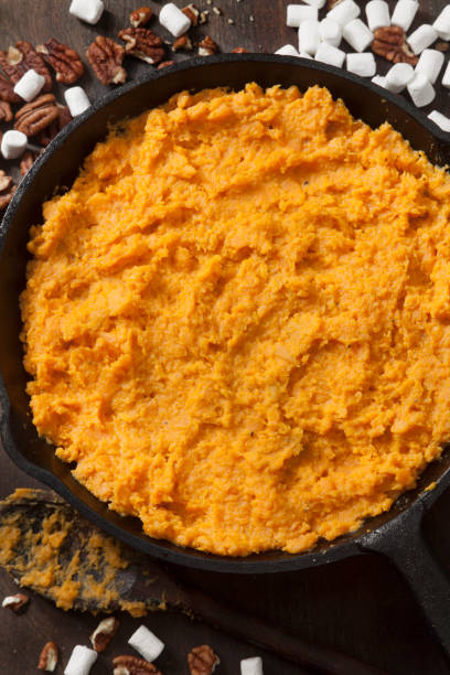 istock Preparing Sweet Potato Casserole with Pecans and Marshmallows 1287113227