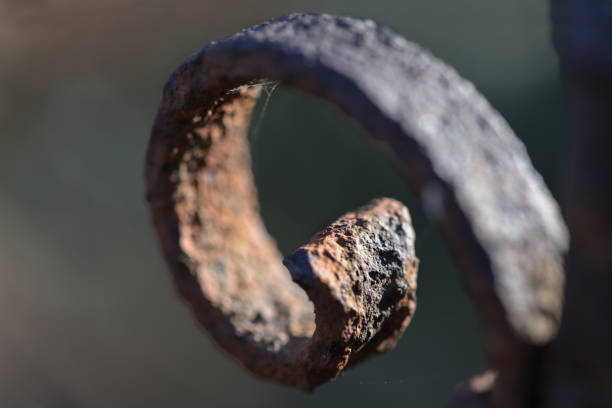 Curlicue decoration on a rusty iron fence, close up shot, copy space, selected focus, very narrow depth of field