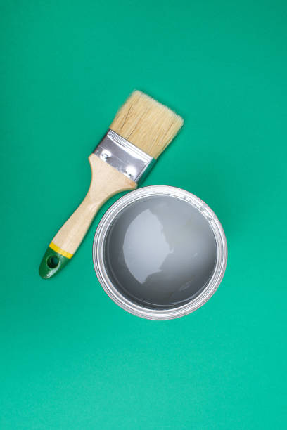 istock Open paint enamel cans on green turquoise palette samples. 1287116166