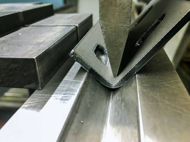 istock Bending sheet metal with a hydraulic bending machine 1287116633