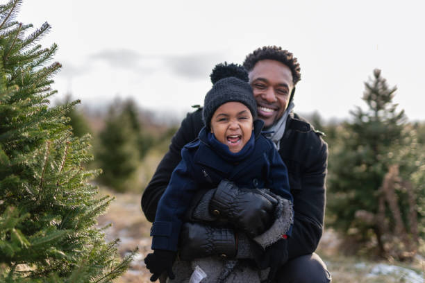 istock A handsome father hugs his cute daughter while they shop for a Christmas tree 1287119420