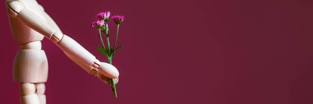 istock Wood man holding flowers 1287119546