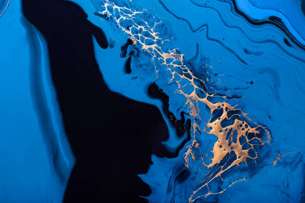 istock Fluid Art. Liquid Metallic Gold in abstract blue wave. Marble effect background or texture 1287119838