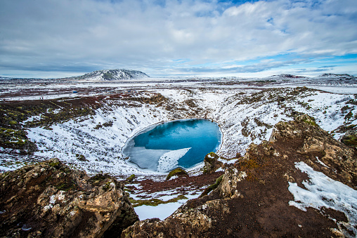 Snowy crater of the Kerid volcano in Iceland