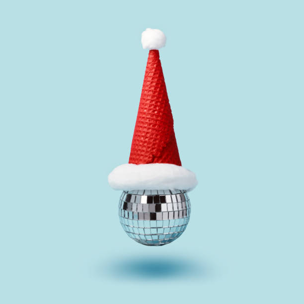 istock Inverted disco ball ice cream and santa hat waffle cone levitates on blue background. Minimal Christmas party concept 1287120613
