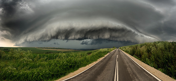 Supercell thunderstorm with dramatic, dark clouds over the road in Bulgarian plains