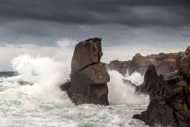 istock Powerful waves crashes in rocky coastline 1287120893