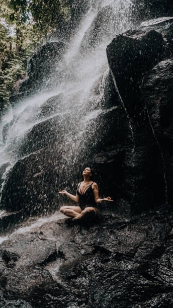 istock relaxed girl under a waterfall in Bali 1287123173