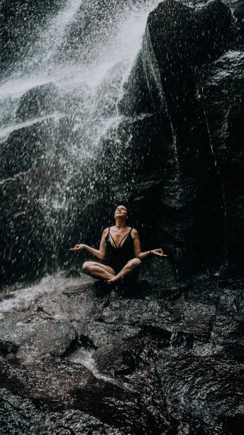 istock relaxed girl under a waterfall in Bali 1287123187