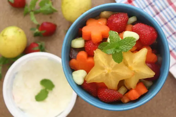Friut salad consist of starfruit, papaya, strawberry and cucumber with yoghurt dressing