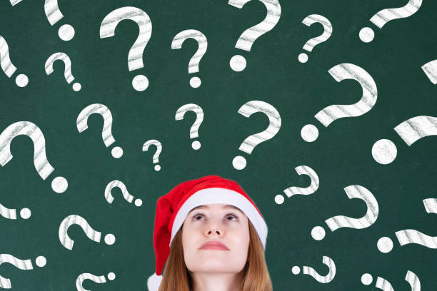 istock Mrs. Claus thinking of gifts with many question marks 1287125924