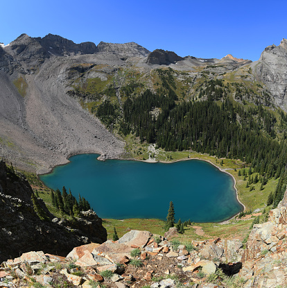 Unbelievably colorful Lower Blue Lake seen from a hiking trail (appr. 11,300 ft) towards Upper Lakes near Mt Sneffels in the Rocky Mountains. This is Mount Sneffels Wilderness of Uncompahgre National Forest,near the City of Ouray, Colorado, United States.