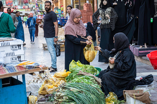 Douz, Tunisia, October 10/2019 typical and traditional Tunisian market, bags full of spices and Tunisian people intent on buying in the market