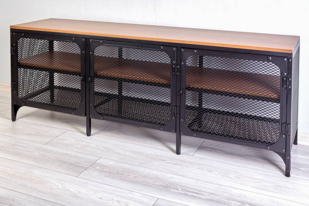 istock Furniture for storing shoes has a metal frame and doors with mesh pattern and chipboard shelves. It can also be used as TV stand in the living room. 1287131661