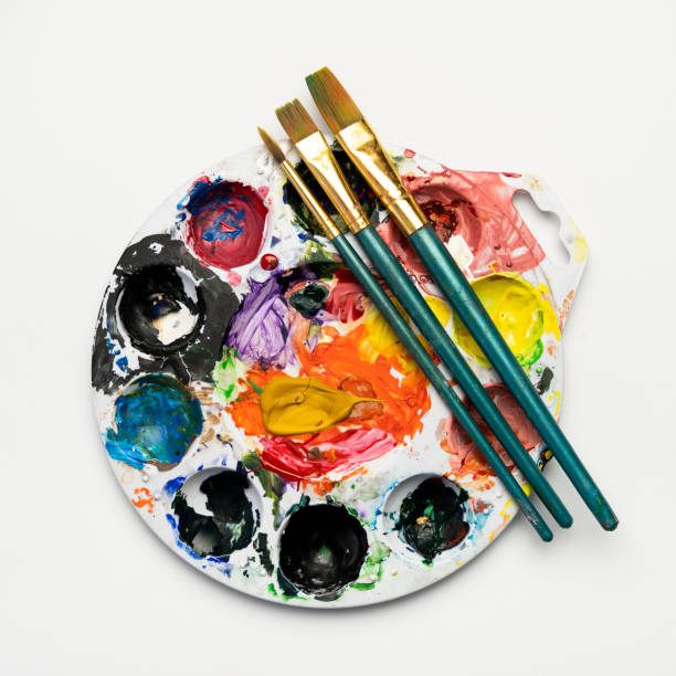 istock Color mixing plate and paintbrushes 1287131760