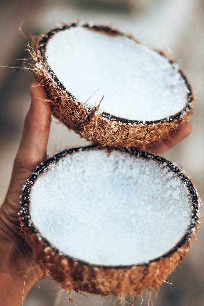 istock Holding coconut in hand close up 1287132639