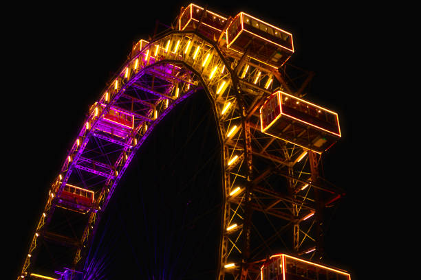 Viennese Giant Ferris Wheel illuminated in the night . Vienna famous amusement park
