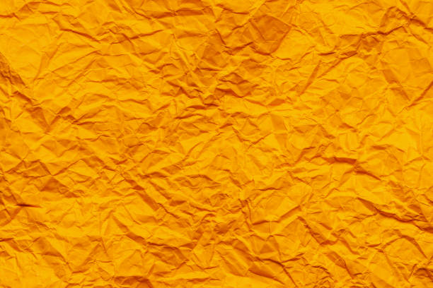 Orange crumpled paper background or texture in detail