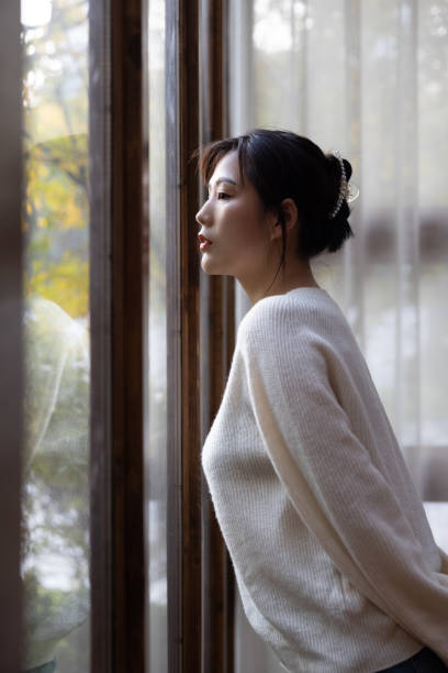 istock Asian young women  by the window 1287139857