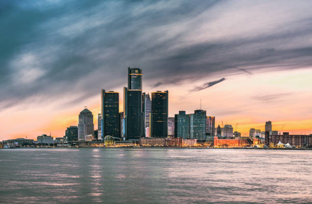 Detroit Skyline at Dusk The Detroit Skyline at dusk as seen from Windsor, Ontario. detroit michigan stock pictures, royalty-free photos & images