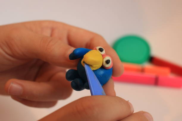 istock The boy is holding a plasticine figurine. 1287145212