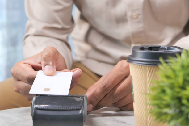 istock contactless payment concept with Payment terminal charging from a card 1287145917