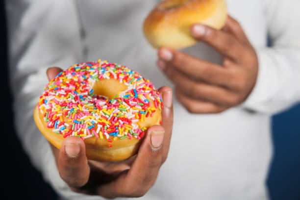 istock Close up of hand holding donuts . 1287146773