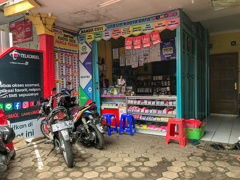 BANDUNG, INDONESIA-NOVEMBER 23, 2020: The shop selling pulse vouchers and data packages looks empty of visitors. During the Covid-19 pandemic, all business sectors were affected so that the economy slowed down.