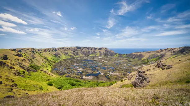 Rano Kau Volcano Crater Lake under blue summer sky. Panorama Shot. Rano Kau is an extinct volcano that forms the southwestern headland of Easter Island, Isla de Pascua, Polynesia, Chile.