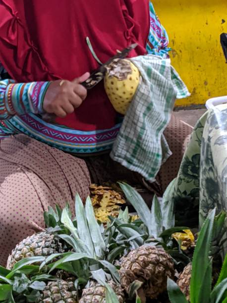 istock Peeling Pineapples at fruit market 1287157004