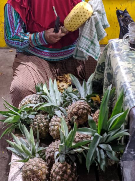 istock Peeling Pineapples at fruit market 1287157016
