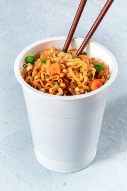 istock Instant noodles with chopsticks in a plastic cup 1287158039