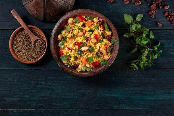 istock Moroccan couscous with ingredients, overhead flat lay shot on a dark background 1287158085