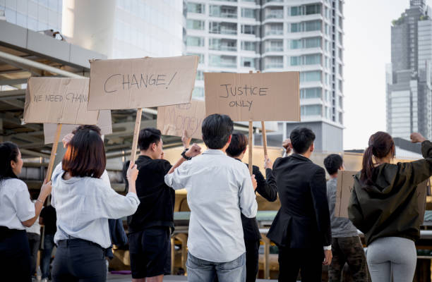 istock Group of young people activists is protesting with placards and posters 1287158314