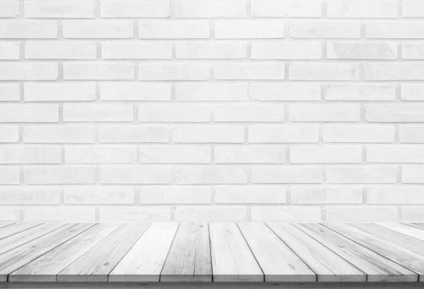 istock Empty wooden table top on white brick wall background, Design wood terrace white. Perspective for show space for your copy and branding. Can be used as product display montage. Vintage style concept. 1287160155